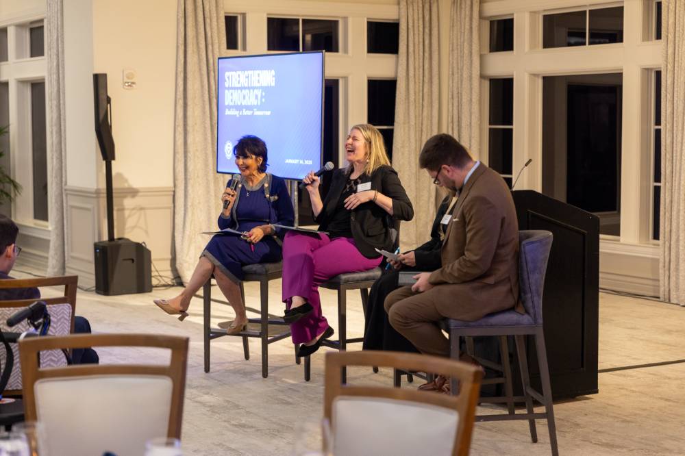 President Mantella on stage with three panelists